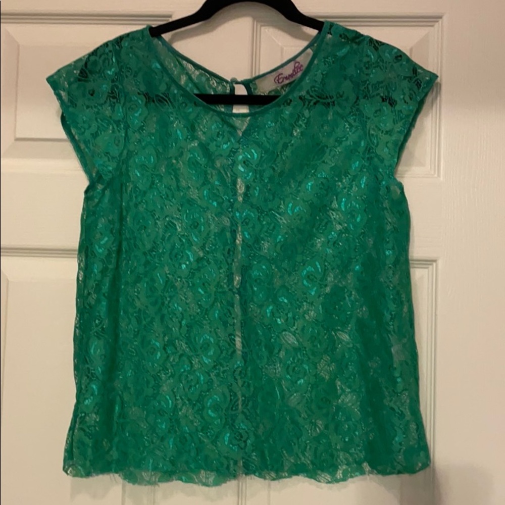 Light green women’s top with button in back